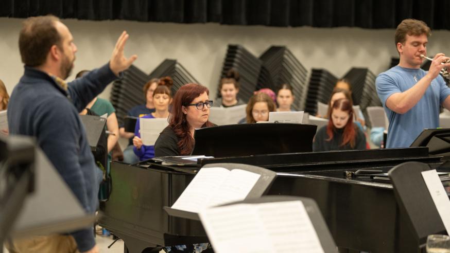 music rehearsal session, wind and brass along with piano and choral 