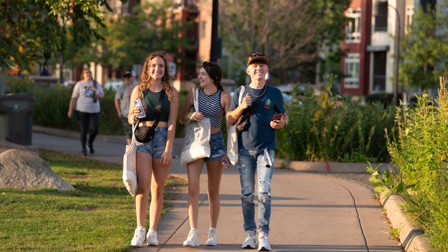 Students walk down the sidewalk at the annual UWEC meets EC event.
