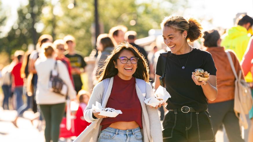 Students laugh and enjoy food at the annual UWEC Meets EC event.