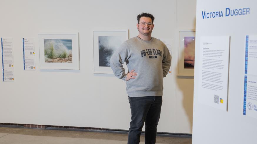 student posing for portrait in Foster Gallery
