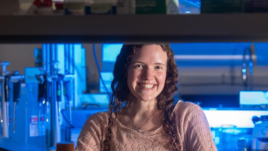 Rachel Horejsi in biology lab, blue light in the background