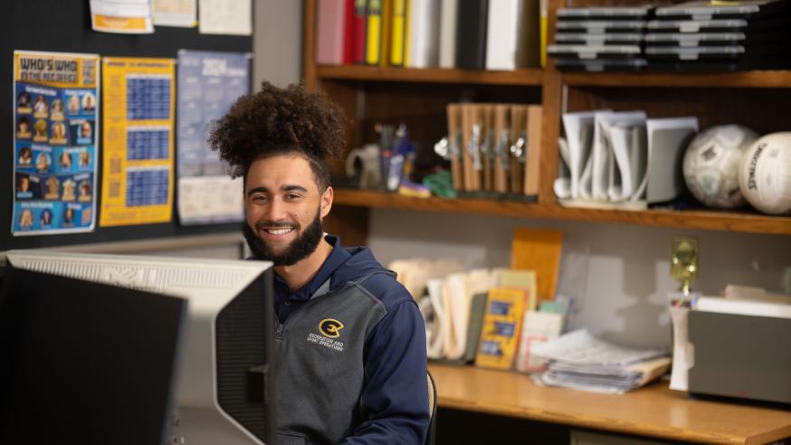 Travis Thompson at his desk in the Recreation & Sport Operations office