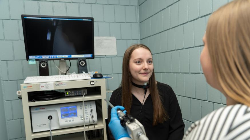 A clinical student performs an exam within the Human Development Center on campus.