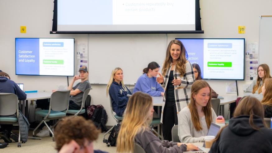 A professor speaks to students in a classroom