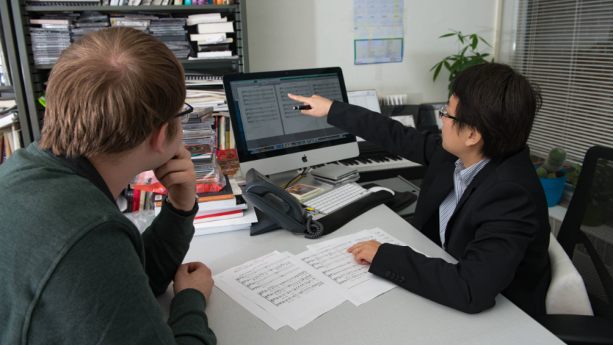 Dr. Chia-Tu Hsu guiding a composition student through their score