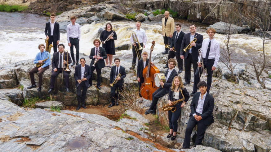 Jazz Ensemble 1 in 2022 posing with instruments at Big Falls State Park
