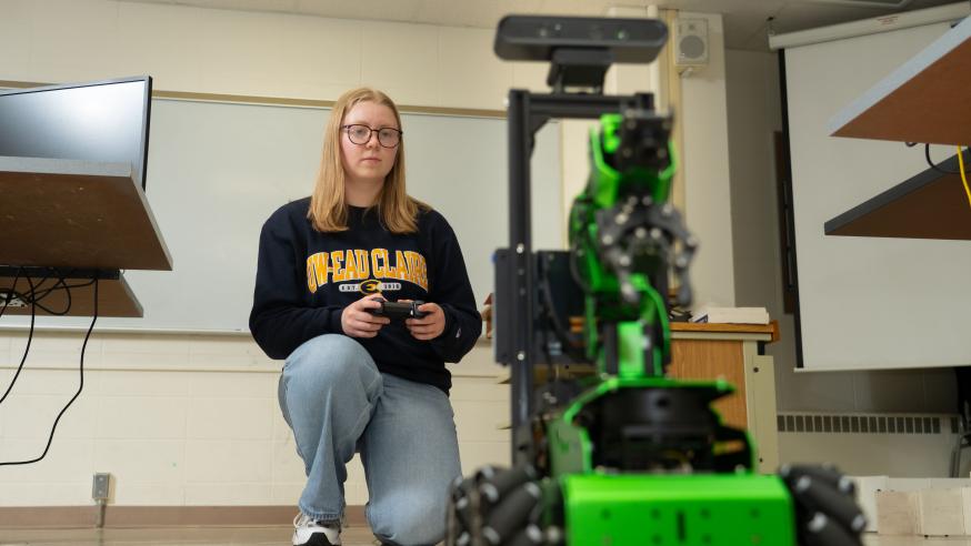 Student controls a moving robot with a remote control