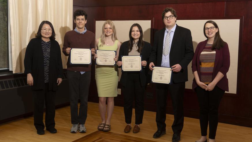 Dr. Kate Kim and Professor Jennine Fox standing next to four graduating students receiving their Digital Analytics Certificates. 
