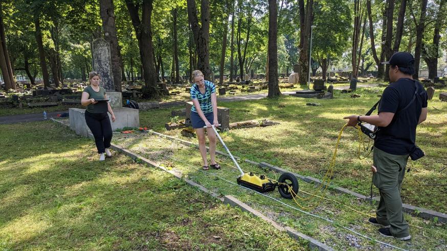 students using ground radar in old cemetery