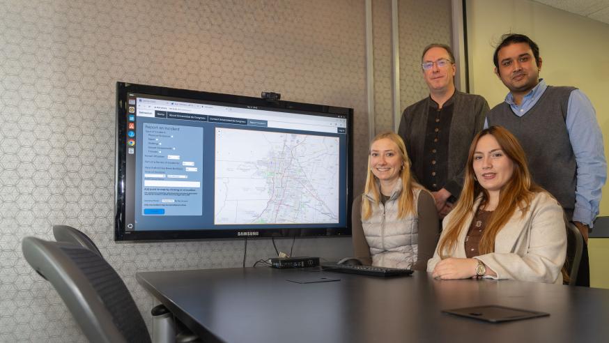 research team in computer lab, two students, two faculty