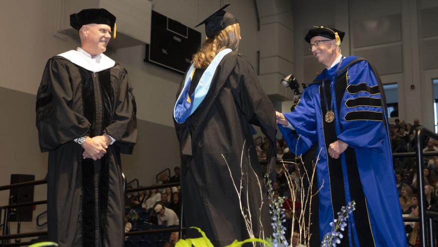 Dr. Michael Carney, interim chancellor at UW-Eau Claire, congratulates a new graduate.