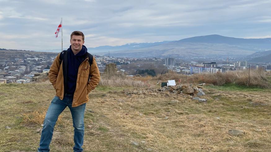 McCullen Willmert stands overlooking a Georgian hillside