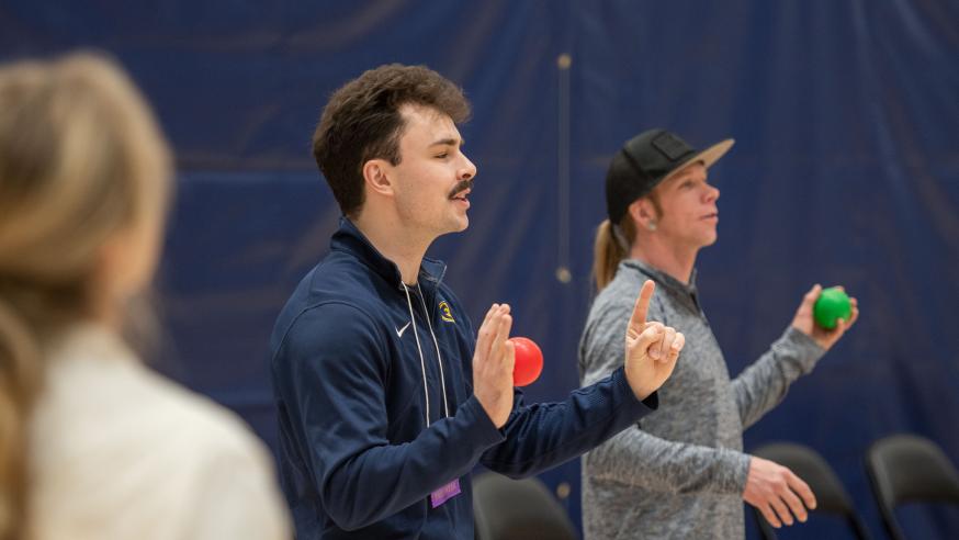 A student leads an activity during a physical education conference at the Sonnentag