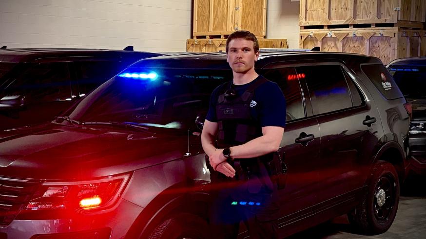 Ian Johnson by squad car 