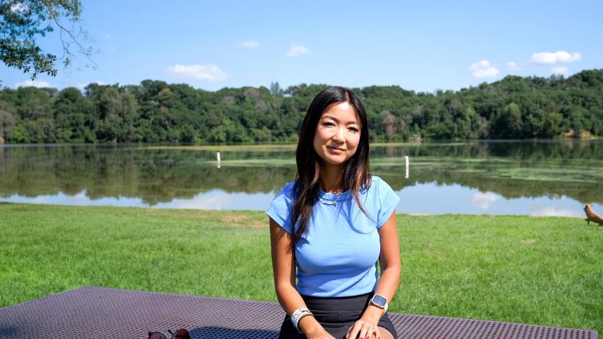 Jenny Anderson alumna outside near a lake, sunny day 