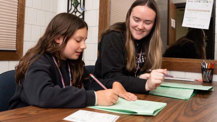 Student tutoring a child