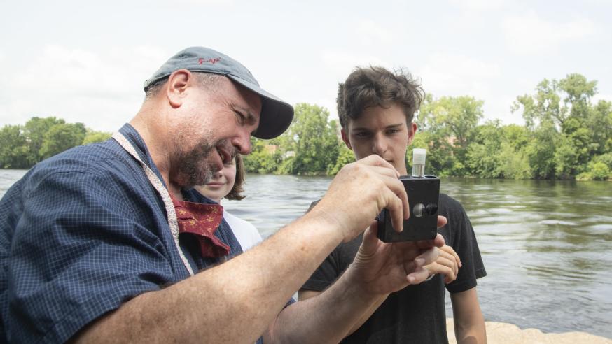 UW-Eau Claire geology professor Dr. J. Brian Mahoney shows high schooler Quinten Anger how to use a colorimetric kit to measure nitrate concentration in the Chippewa River. (Submitted photo)