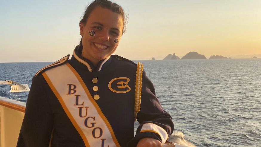 Girl in marching band uniform on the deck of a cruise ship
