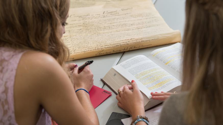 Two students discuss the Bill of Rights and U.S. Constitution in the Hibbard Hall Political Science study area