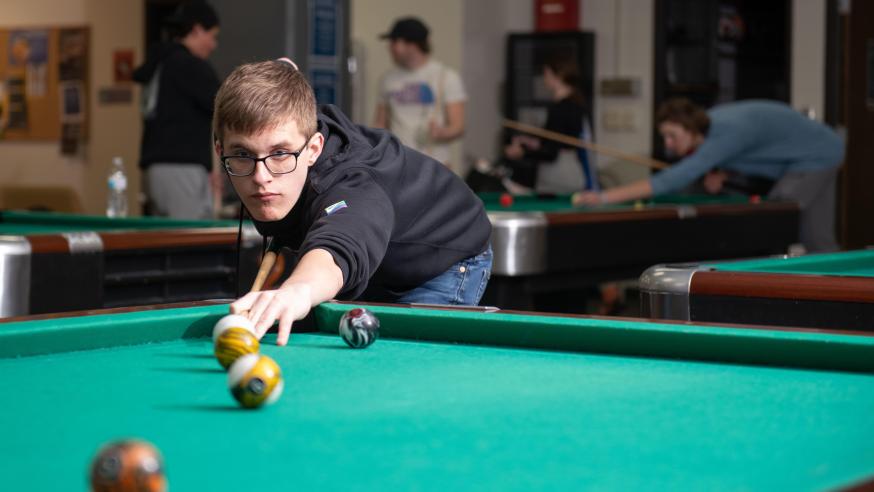 Student playing pool