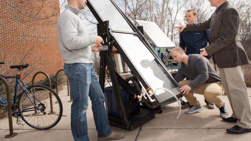 Blugolds work on a solar panel on campus