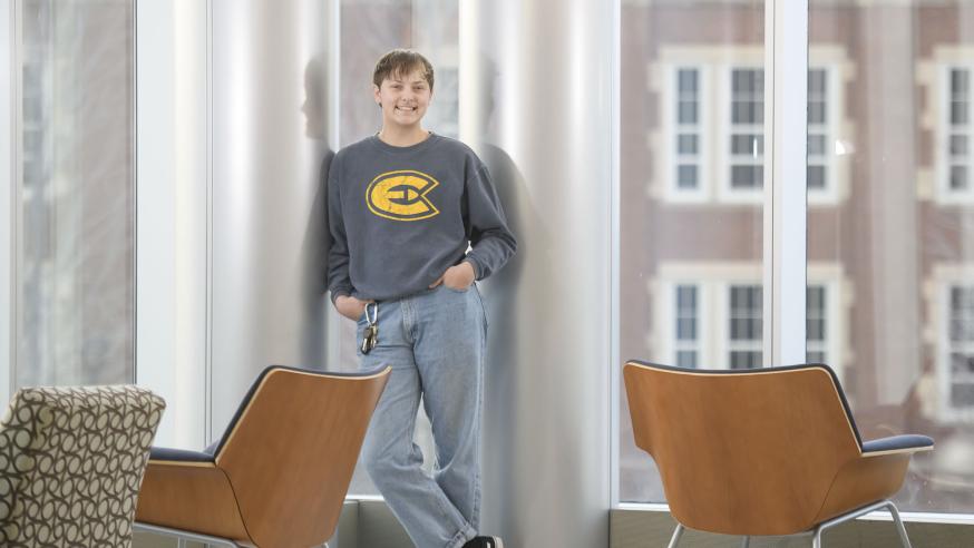 student standing in windows in Centennial Hall