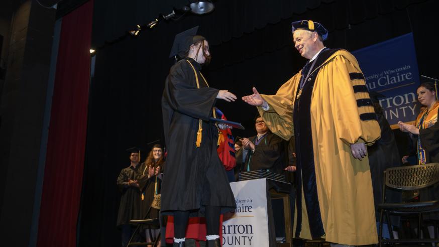 student shaking Chancellor Schmidt's hand at UW-Eau Claire Barron County