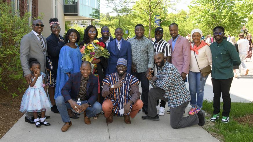 large family group shot from graduation, some members in traditional African clothing