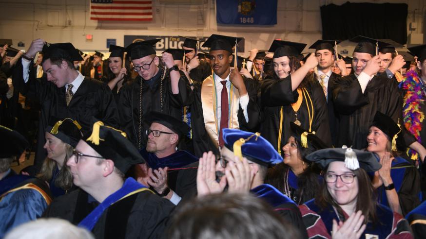 graduates tossing the tassel on their caps