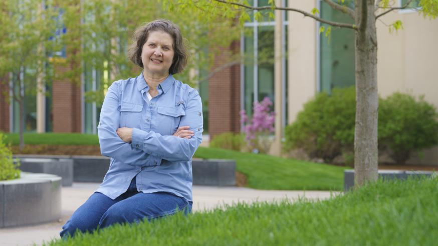 Daria Hutchinson sitting by the Sprites statue