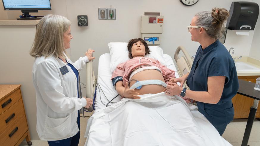 Nursing faculty work with new simulation manikin
