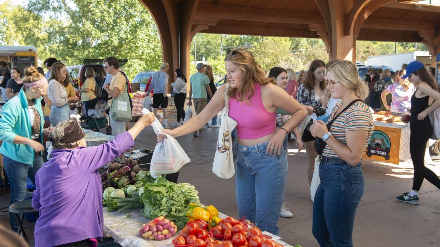 students at the Farmers' Market making a purchase