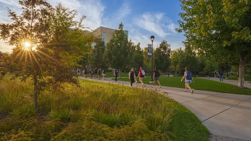 students walking through the Stowe Gateway and Garfield Ave mall on a fall day