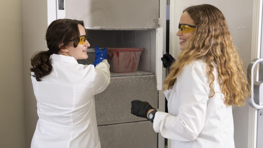 Faculty member Jennifer Smith on the right and research student on the left removing samples from the deep freeze