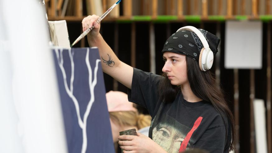 art student painting at an easel