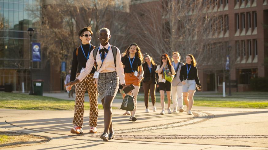 students attending 2023 NCUR conference walking on campus on a sunny day
