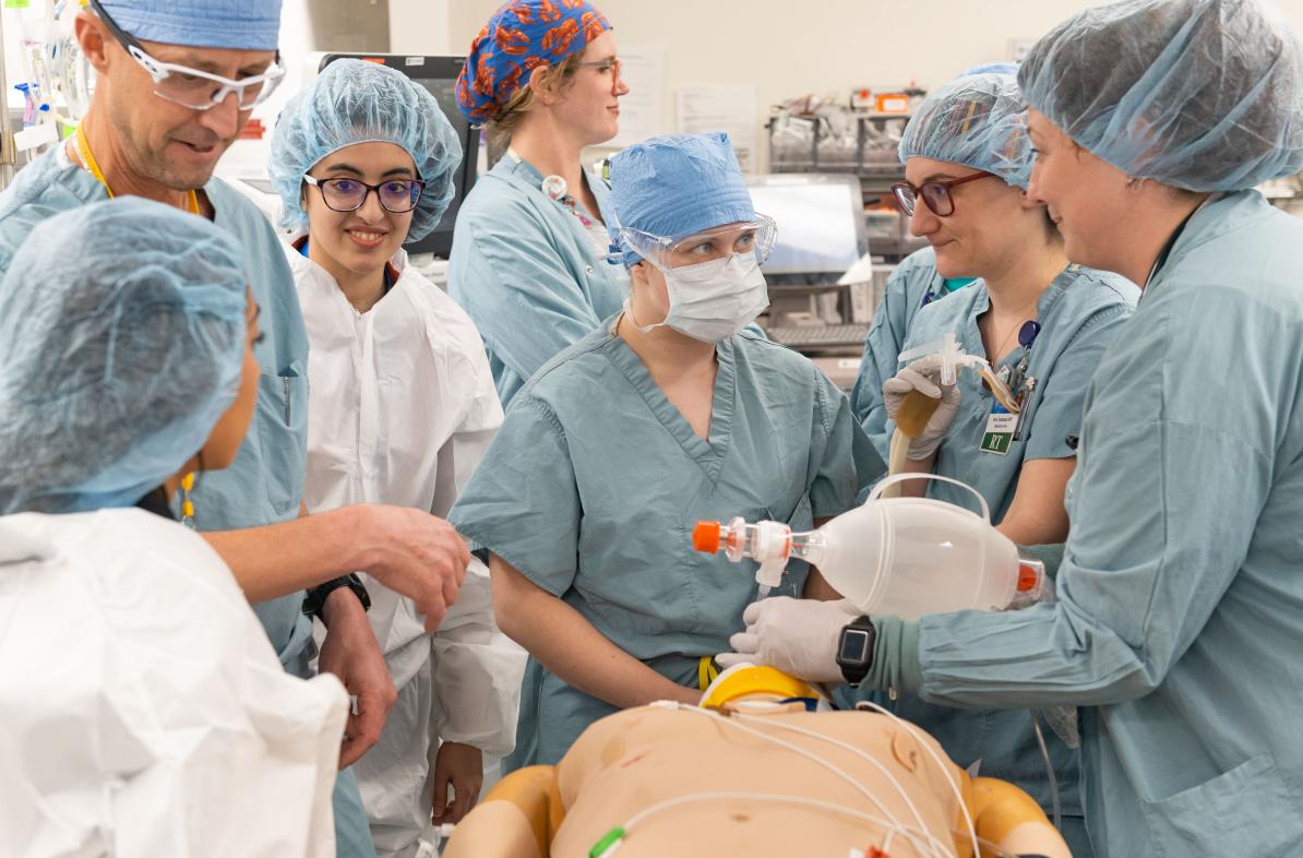 A student works among Mayo doctors during a simulation drill.