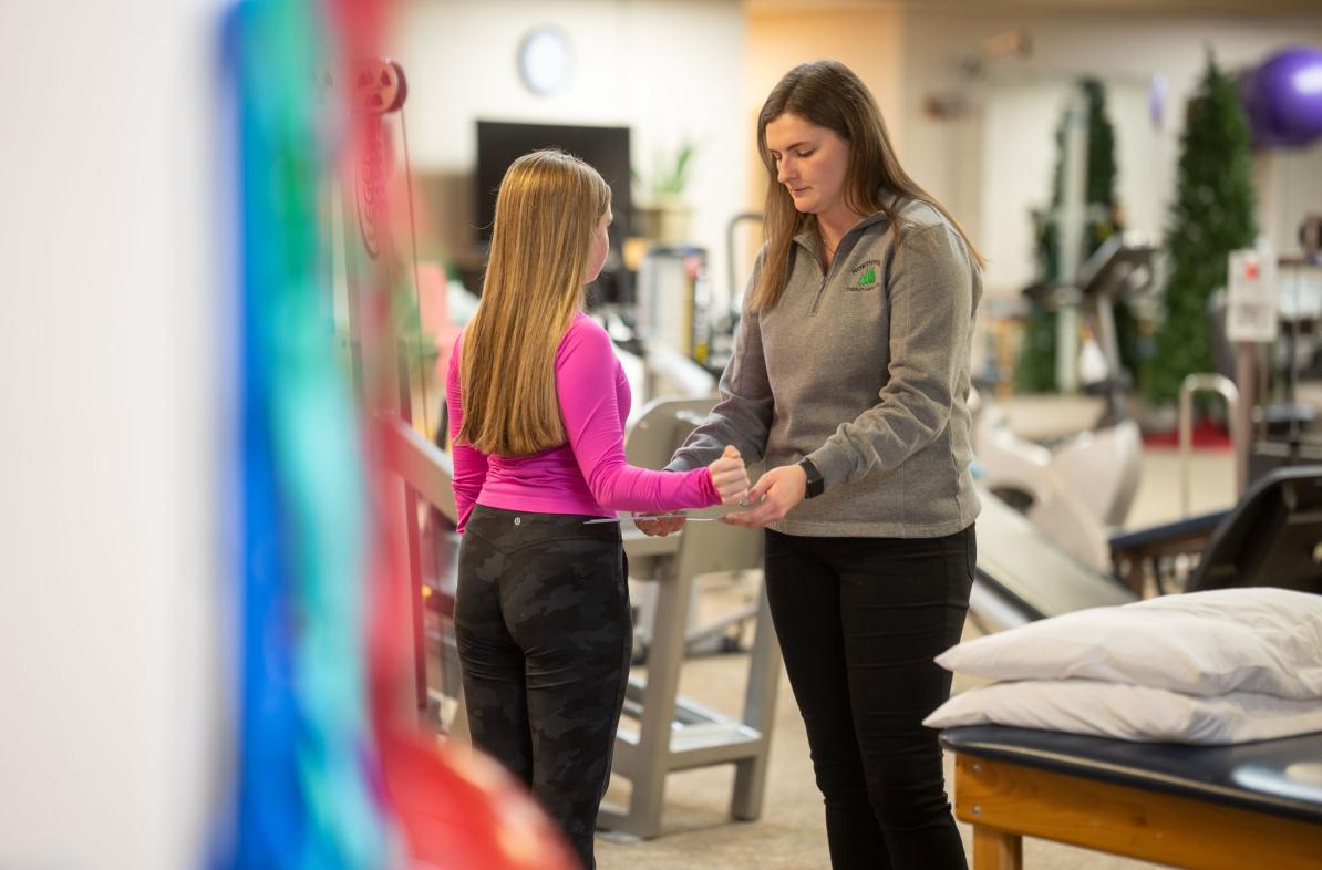 Physical therpist working with a young patient in the Northwoods Therapy clinic