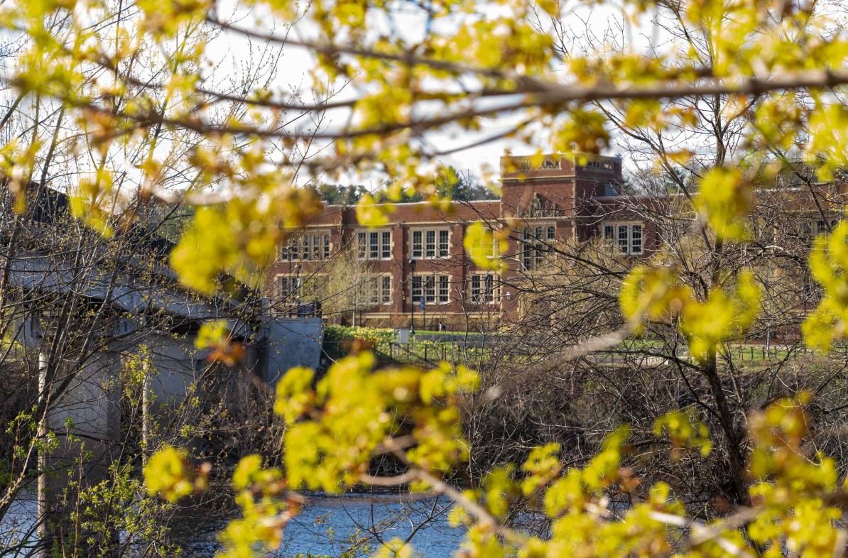 A shot of Schofield Hall during the fall with fall leaves framing the shot.