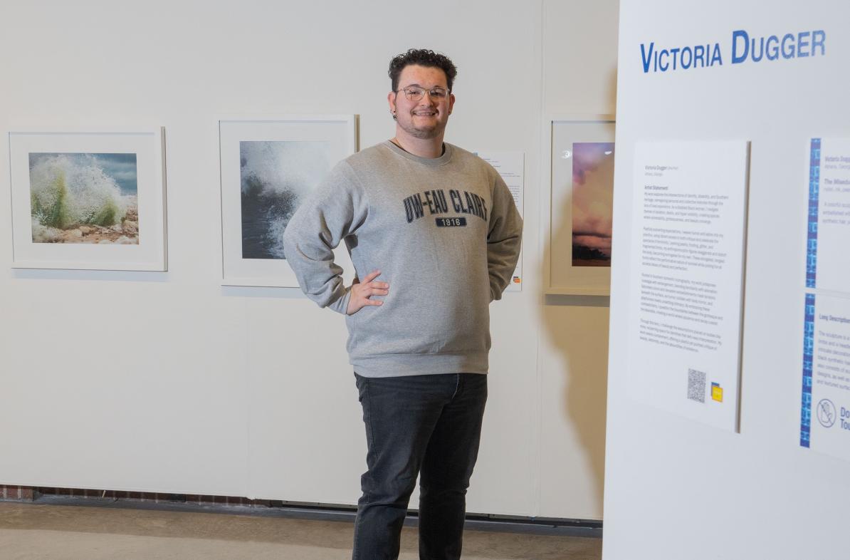 student posing for portrait in Foster Gallery 