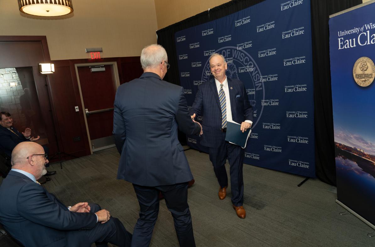 Chancellor Schmidt shaking hands with Dr. Michael Carney