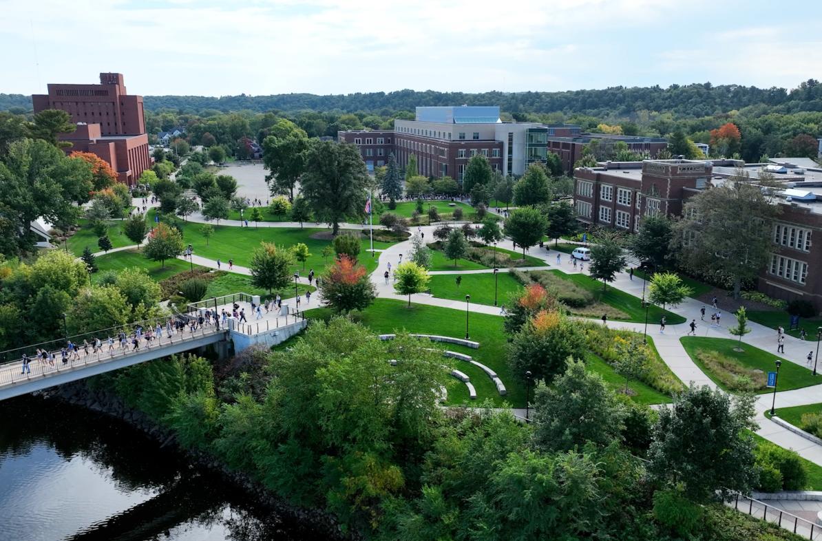 drone shot of campus from river 