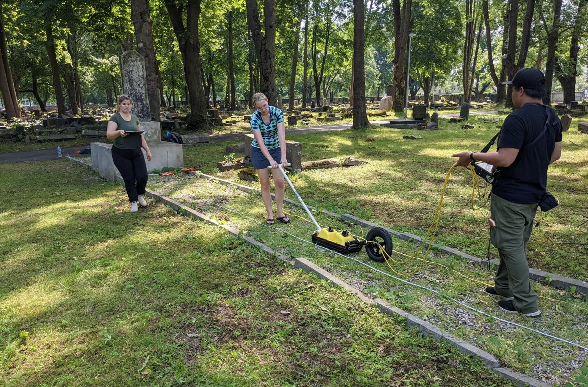 students using ground radar in old cemetery