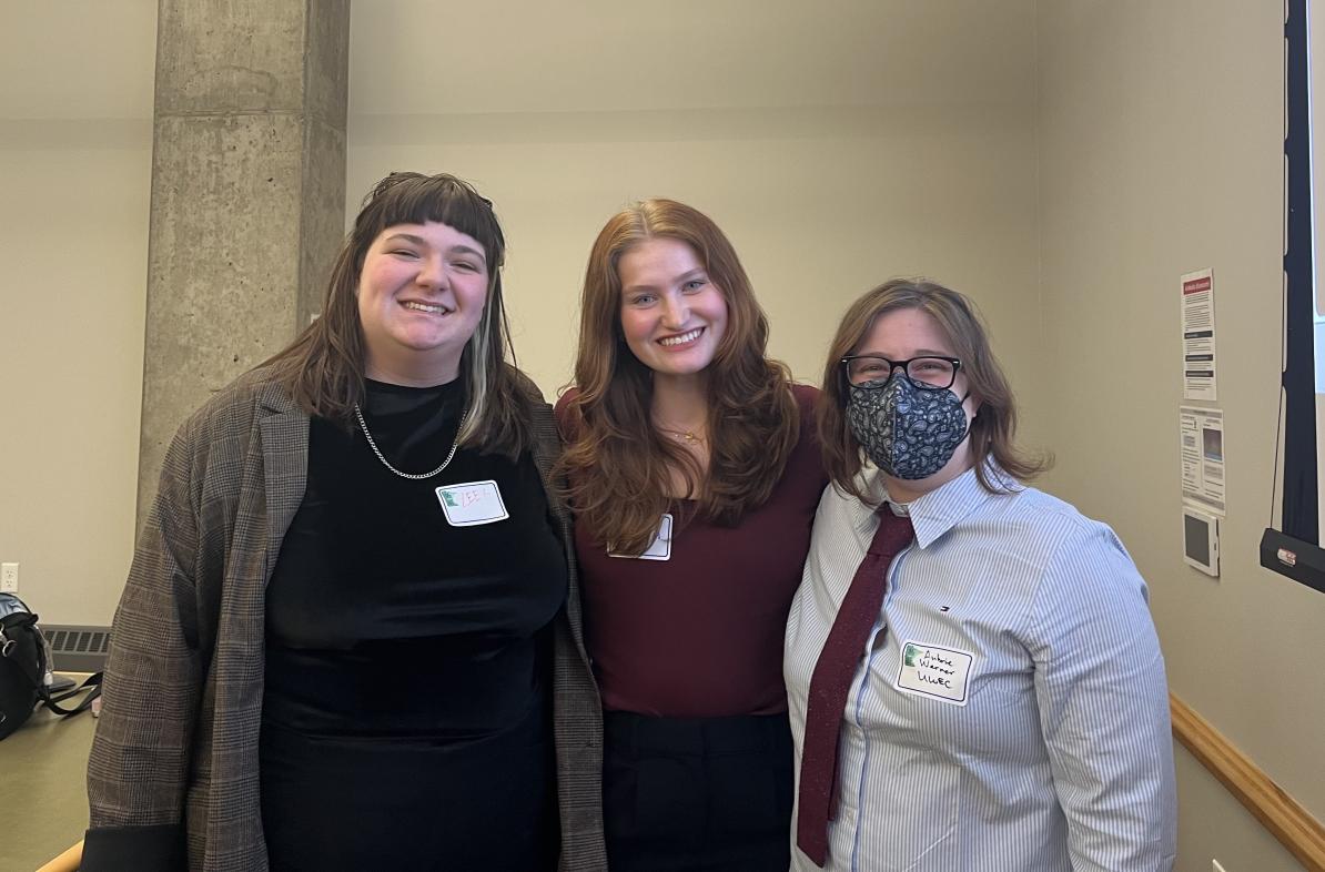 UWEC students Lee Rutzinski and Bree Muske and Writing Center assistant director Aubrie Warner grouped and smiling after a presentation 