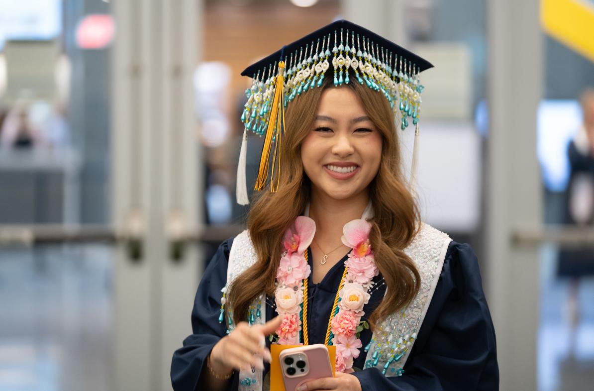 Student in cap and gown, cap decorated with Hmong beading 