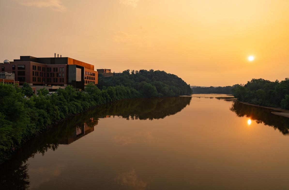 A view of the sun setting on the Chippewa River. The Riverside Science Center is in the background.