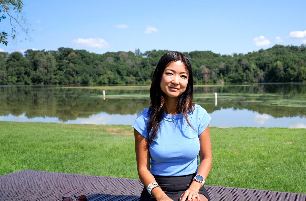 Jenny Anderson alumna outside near a lake, sunny day 