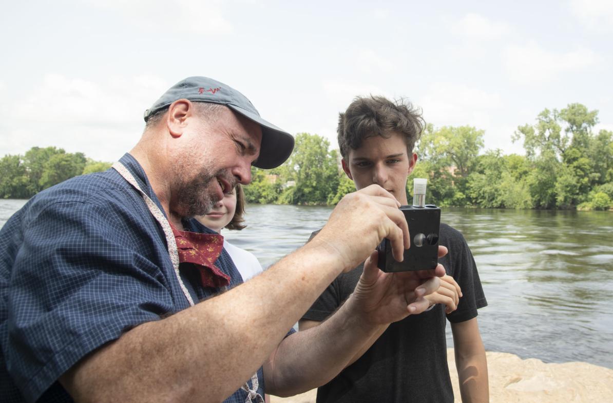 UW-Eau Claire geology professor Dr. J. Brian Mahoney shows high schooler Quinten Anger how to use a colorimetric kit to measure nitrate concentration in the Chippewa River. (Submitted photo)
