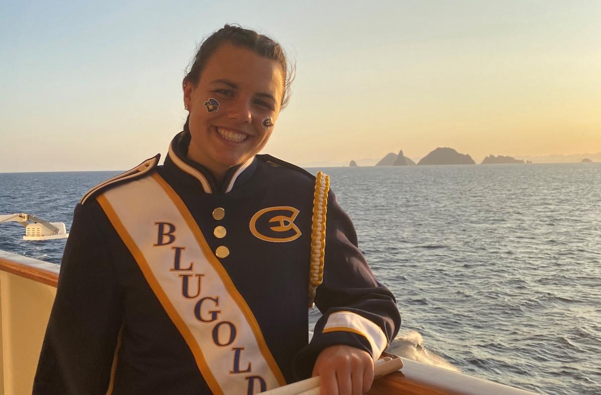 Girl in marching band uniform on the deck of a cruise ship