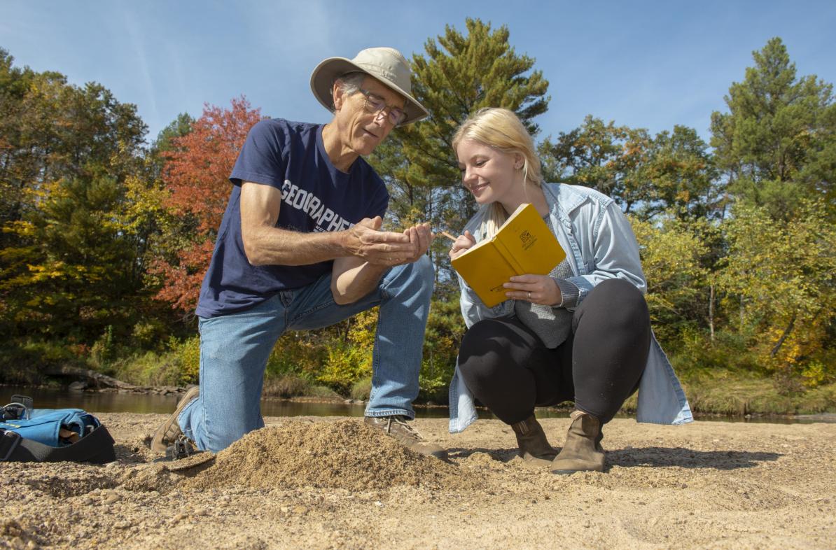 Dr. Douglas Faulkner, professor of geography, and Grace Bowe, an environmental studies major, examine the banks of western Wisconsin rivers as part of a faculty-undergraduate student research project. (Photo by Shane Opatz)